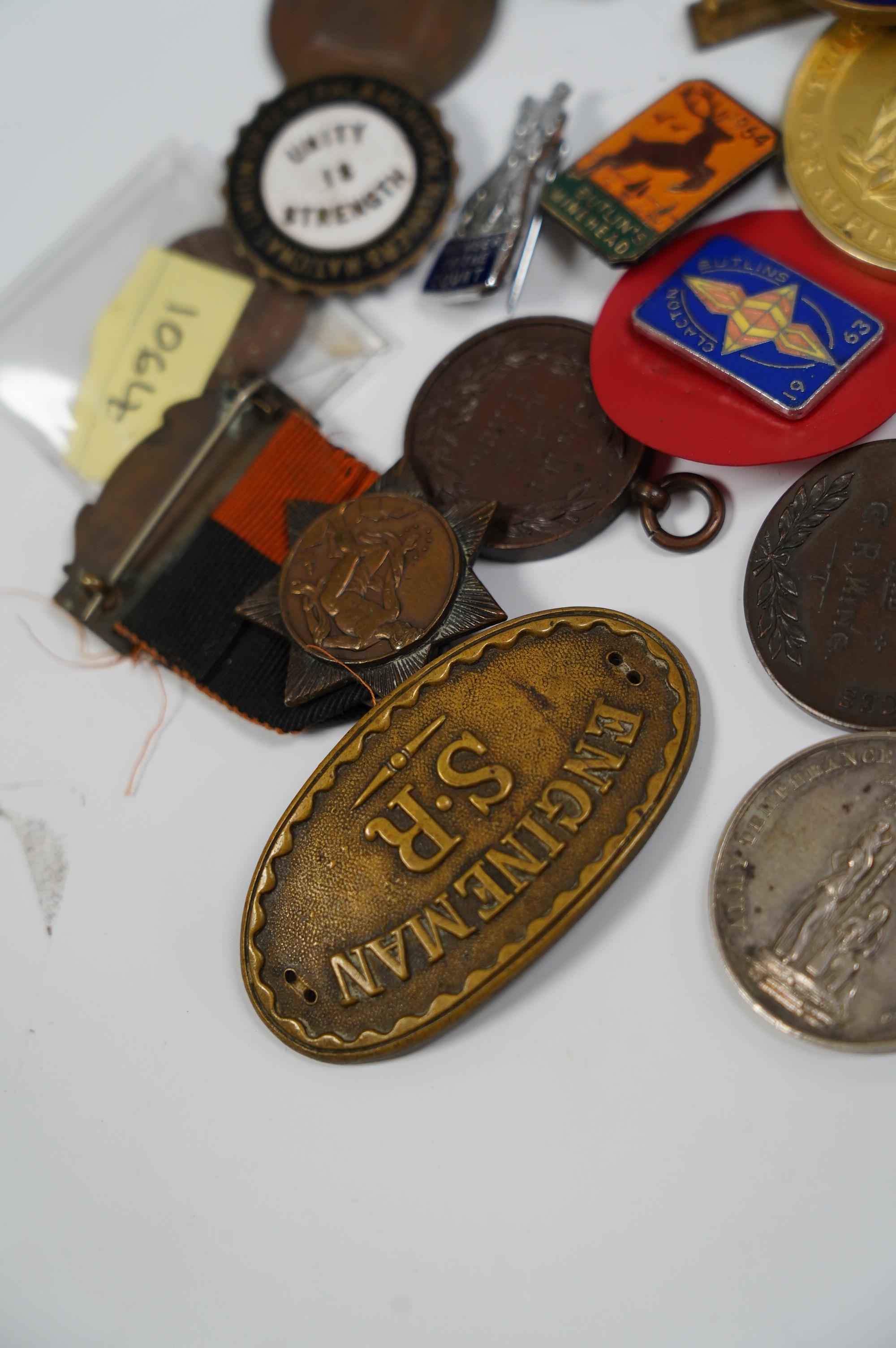 A group of assorted tokens, medallions and badges